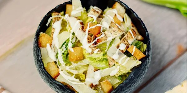 Premium plated salad featuring fresh mixed greens, golden croutons, shredded cheese, and quality ingredients ideal for food service and wholesale distribution.