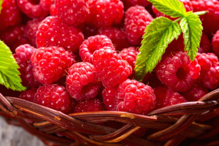 Raspberry In A Basket .on Wooden Background
