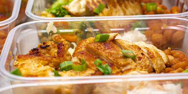 Grilled chicken, rice, and beans in meal prep containers for a healthy, balanced diet.